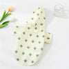 A light cream cartoon printed dog raincoat featuring green cactus patterns, displayed on a white surface.