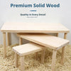 A light wood hamster climbing platform is shown resting on a natural fiber surface.