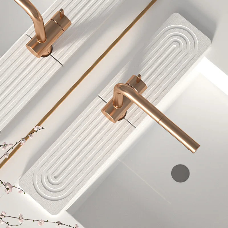 A brass diatomaceous earth absorbent mat is shown mounted on a white wall, featuring a modern spiral design.