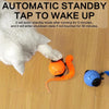 A gray cat is interacting with an orange automatic standby tap to wake up pet toy.