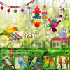 Natural wooden swing and chewing toys for various small to medium birds hanging from a wire grid.