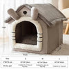 A gray pet house with a textured roof and entrance, designed for dogs.