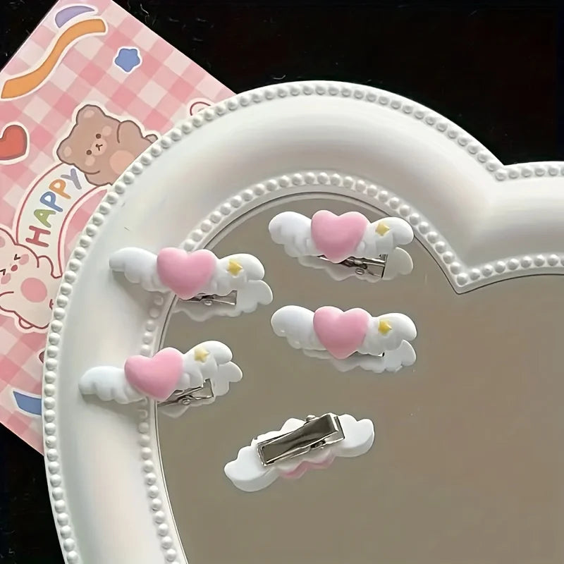 A white heart-shaped tray holds several small white clips with pink hearts and silver clasps.