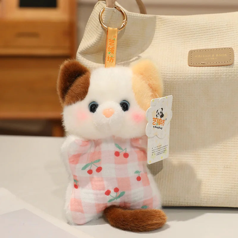 A cute cartoon animal bean bag plush toy resembling a white cat with brown ears and a pink checkered body, displayed next to 