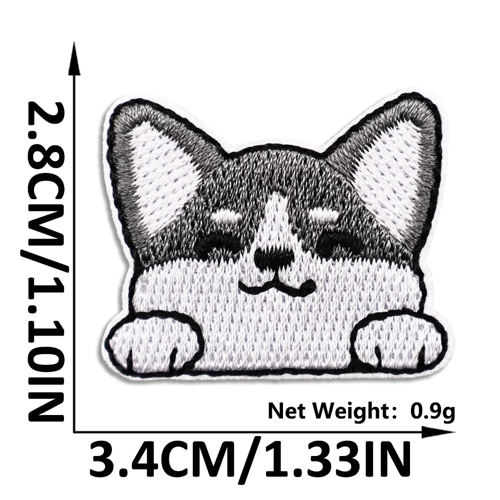 A black and white embroidered cat face patch for clothing and DIY projects.