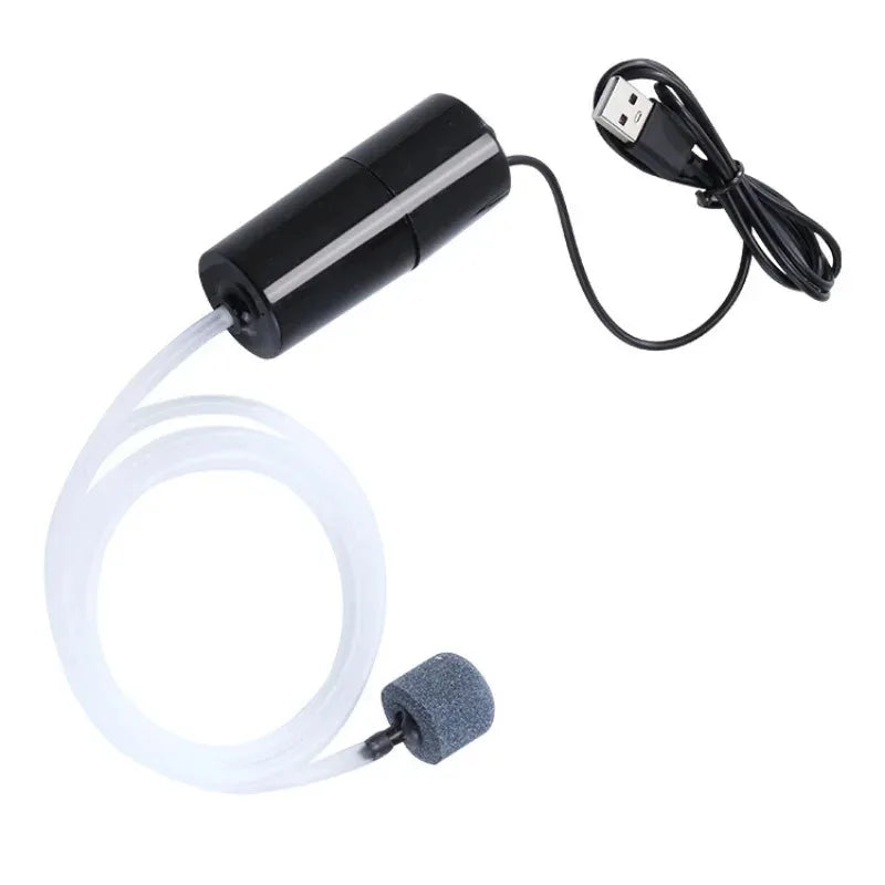 A portable USB aquarium air pump with a coiled white hose and a black power cord.