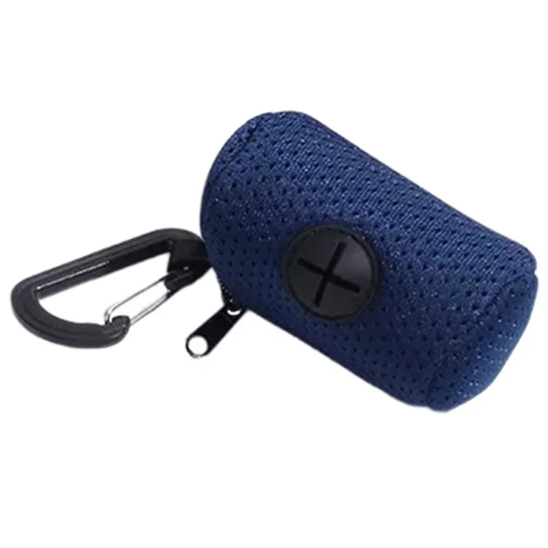 A dark blue pet waste bag dispenser featuring a mesh texture and a metal leash clip.