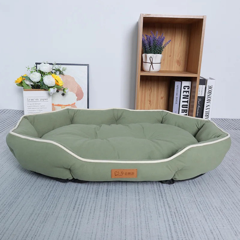 A light green corduroy pet sofa bed for dogs and cats resting on a gray surface.