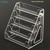 A clear acrylic display stand designed for holding business cards and brochures.