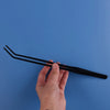 A hand holds a black stainless steel aquarium plant trimming tool set against a blue background.