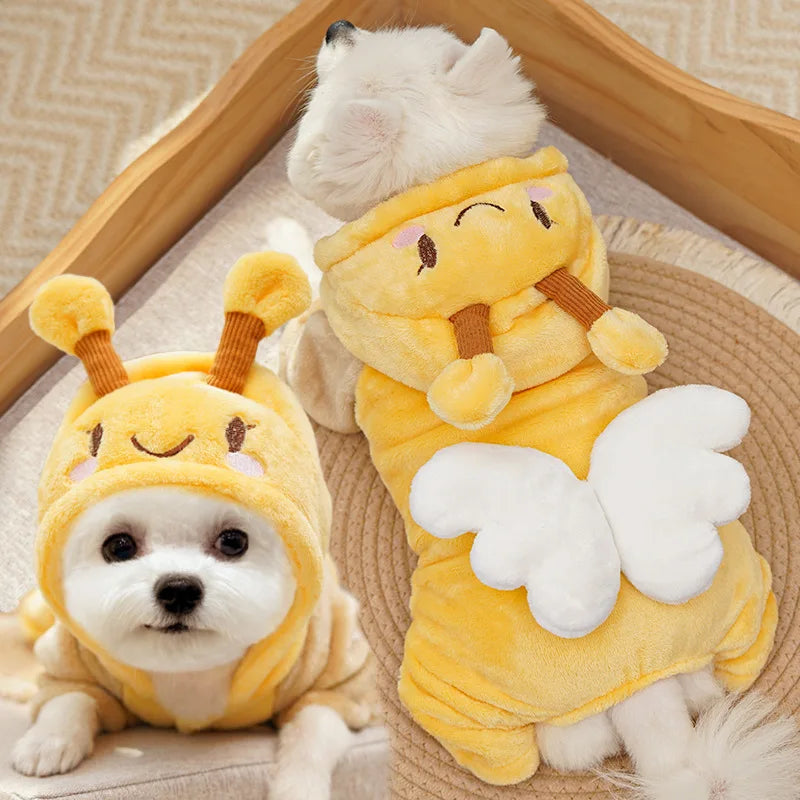 A fluffy yellow fleece dog hoodie with animal ears is shown resting on a beige woven surface.