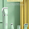 A light green pet clipper and its attachments are displayed on a white surface next to yellow curtains.