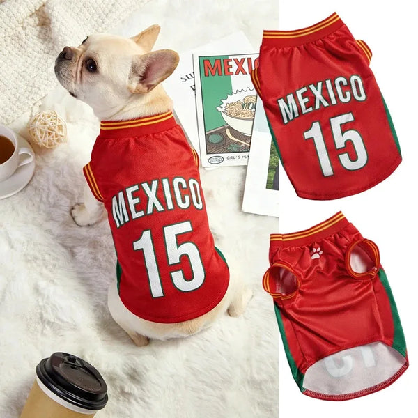 A small dog wearing a red sports jersey with the number 15, featuring the text MEXICO.