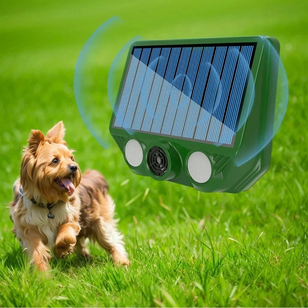 A green solar pest repellent device is shown hovering above a happy dog in a grassy outdoor garden.