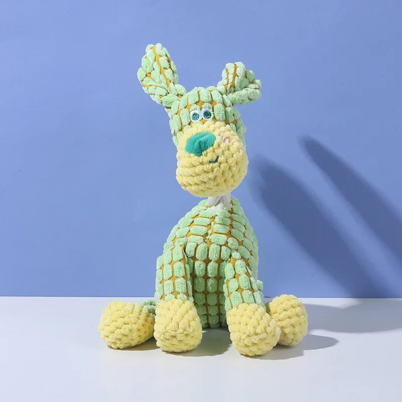 A light green squeaky plush toy shaped like a donkey dog with textured teeth