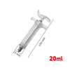 A clear plastic syringe with a metal tip and markings, used for feeding small animals.