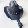 A black felt cowboy hat with gold star trim, shown against a white background.