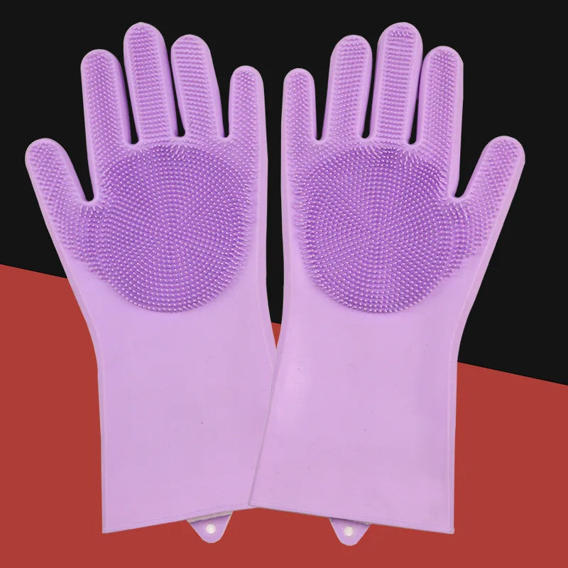 A pair of light purple pet grooming gloves for dogs and cats displayed on a reddish-orange surface.