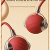 A red textured ball pet toy is shown with a cord, resting on a beige surface.