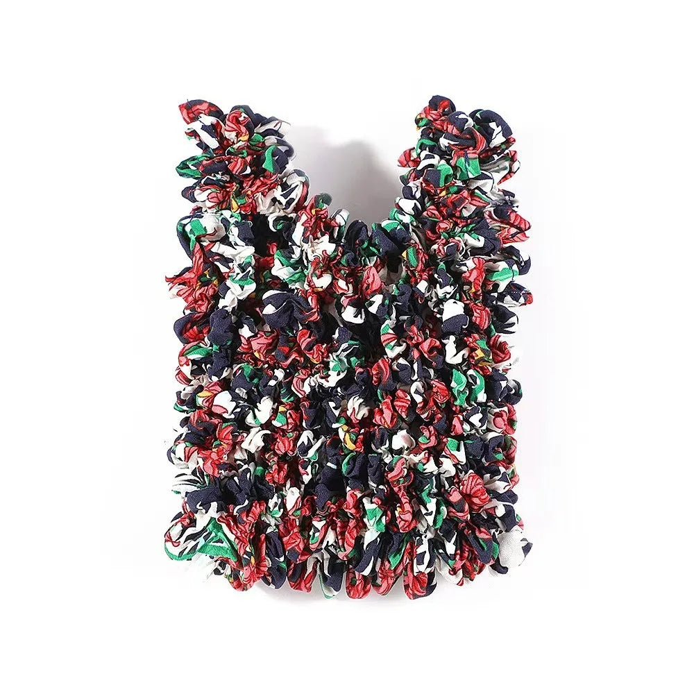 A reusable foldable bubble shopping bag made of ruffled fabric in red, black, and white.