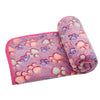 A rolled pink and purple fluffy pet blanket or mat with floral patterns.