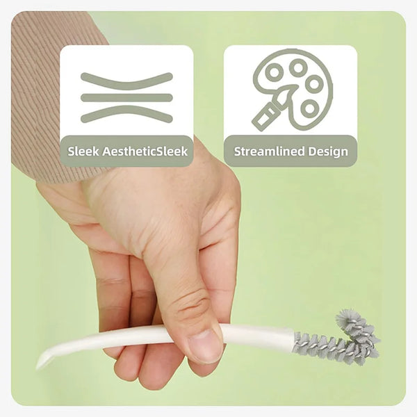 A hand holds a white cleaning brush with a bristled end, demonstrating the sleek aesthetic and streamlined design of a pet ca