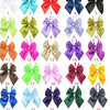 A collection of twenty-five colorful satin bow ties in various shades including pink, purple, green, yellow, and black for pe