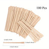 Ein Bund von 100 Einweg-Holz-Haarentfernungsstäbchen, hellbeige.