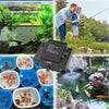 A black aquarium air pump and accessories are shown alongside various fish and aquatic plants in a natural outdoor setting.