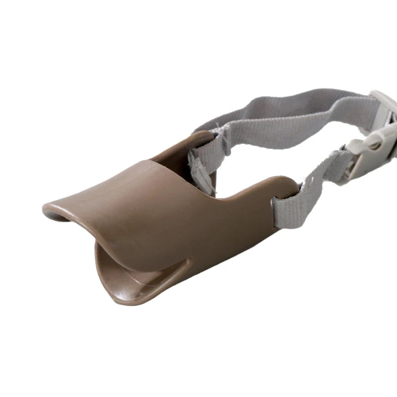 A brown training muzzle for small dogs with a gray strap.