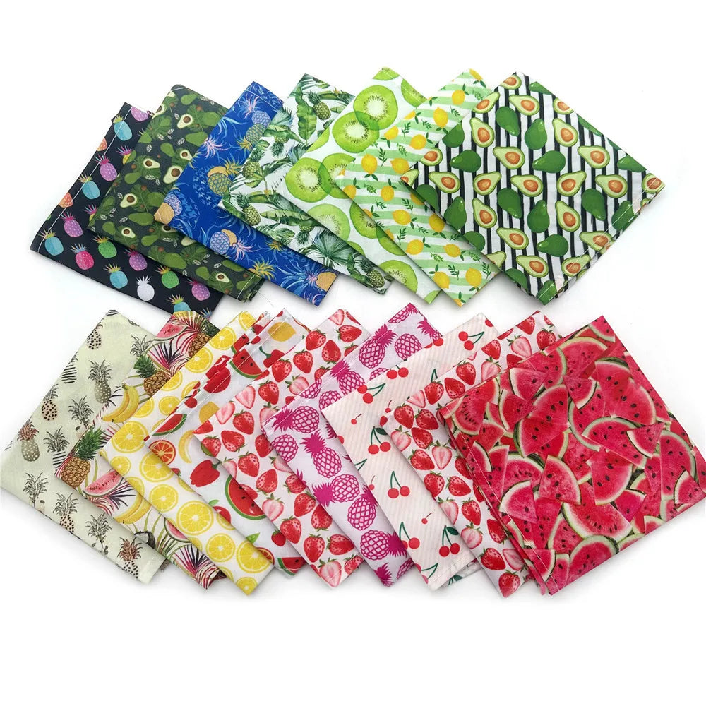 A collection of colorful summer fruit print dog bandanas and triangle scarves made of soft cotton.