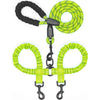 A bright lime green durable leather double dog leash with a black handle and shock absorbing bungee.