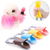 A collection of colorful quack-free training muzzles for small dogs, including pink, yellow, blue, and brown.