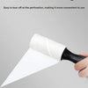 A hand is holding a slanted tear design lint roller, showing the white roller material and black handle.