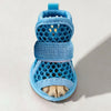 A pair of light blue breathable mesh dog shoes with a blue strap and a light tan paw pad.