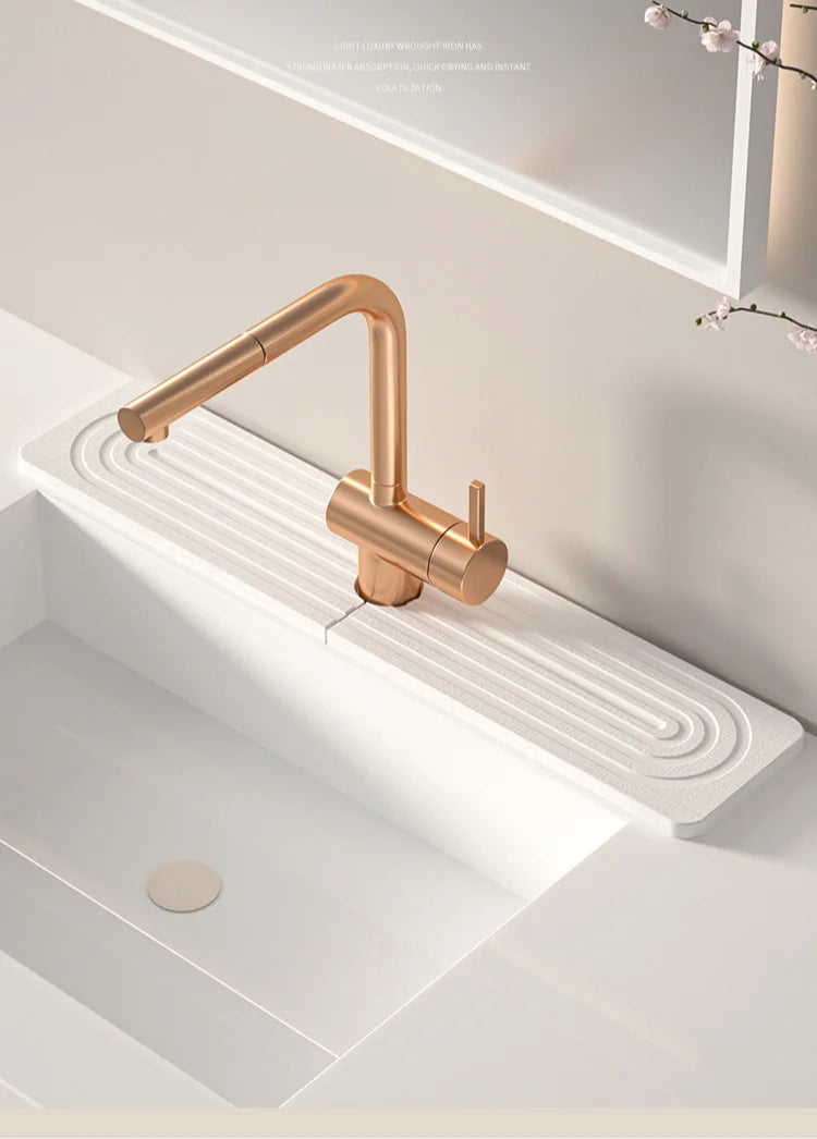 A modern brass faucet mounted on a white countertop, used as a diatomaceous earth quick-dry absorbent mat.