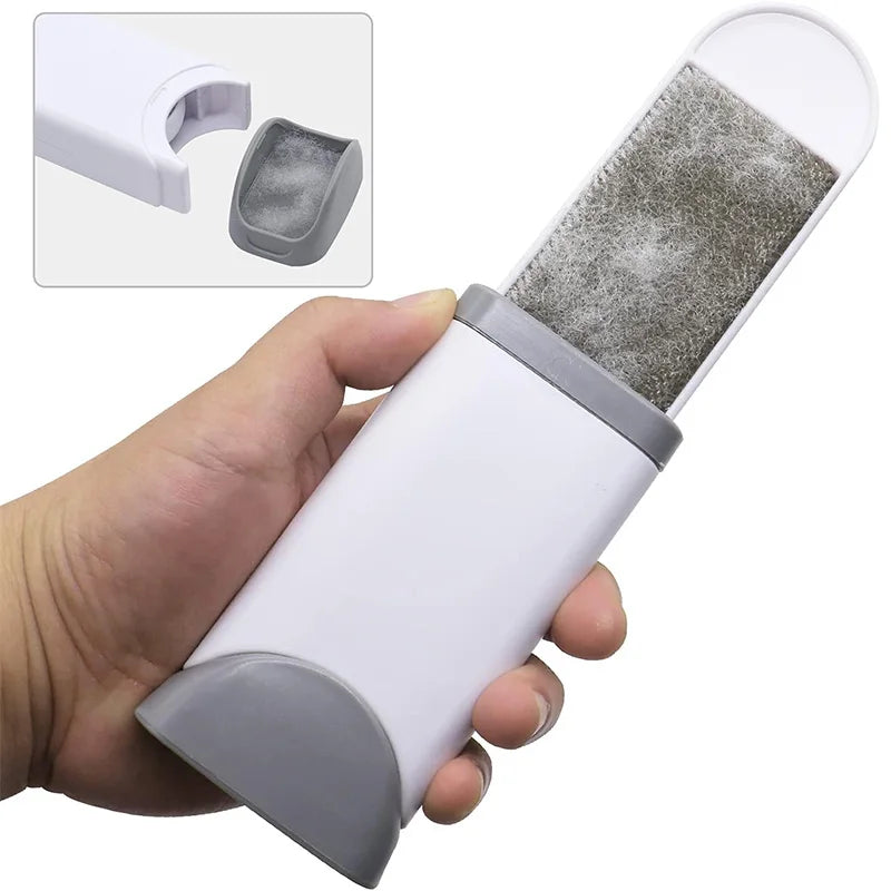 A hand holds a white lint remover brush with a gray textured cleaning pad, showing the product and its components.