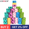 A stack of colorful printed self-adhesive elastic bandage tape rolls in various shades of blue, green, and pink.