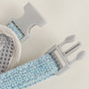 A light blue padded harness and leash set for a small pet, showing the white plastic components.
