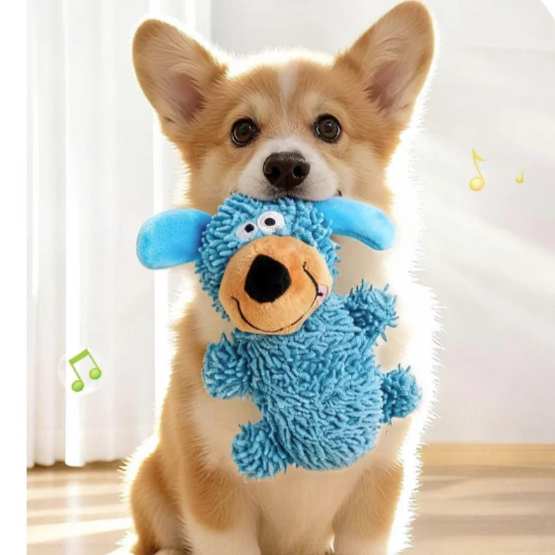A small dog wearing a blue plush chew toy with floppy ears and a smiling face.