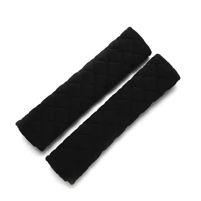 Black plush car seat belt shoulder protector shown diagonally.