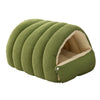 A green plush cat cave bed with a ribbed exterior and a removable beige lining.