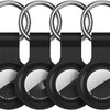 A black silicone protective cover for an AirTag attached to a metal keychain ring.