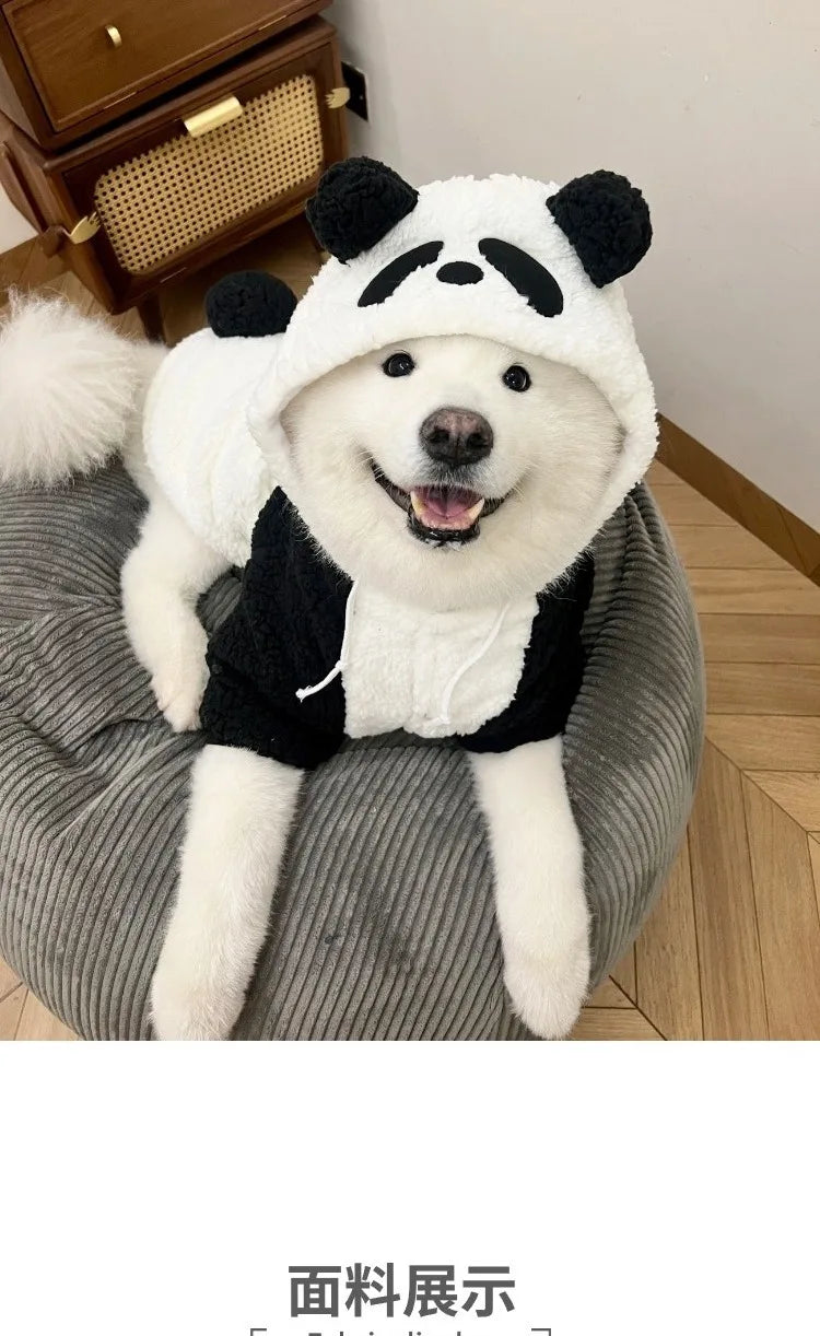 A white and black panda-themed fleece winter dog hooded coat displayed on a gray surface.