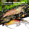 A life-like shrimp lure is shown swimming in a natural underwater environment.