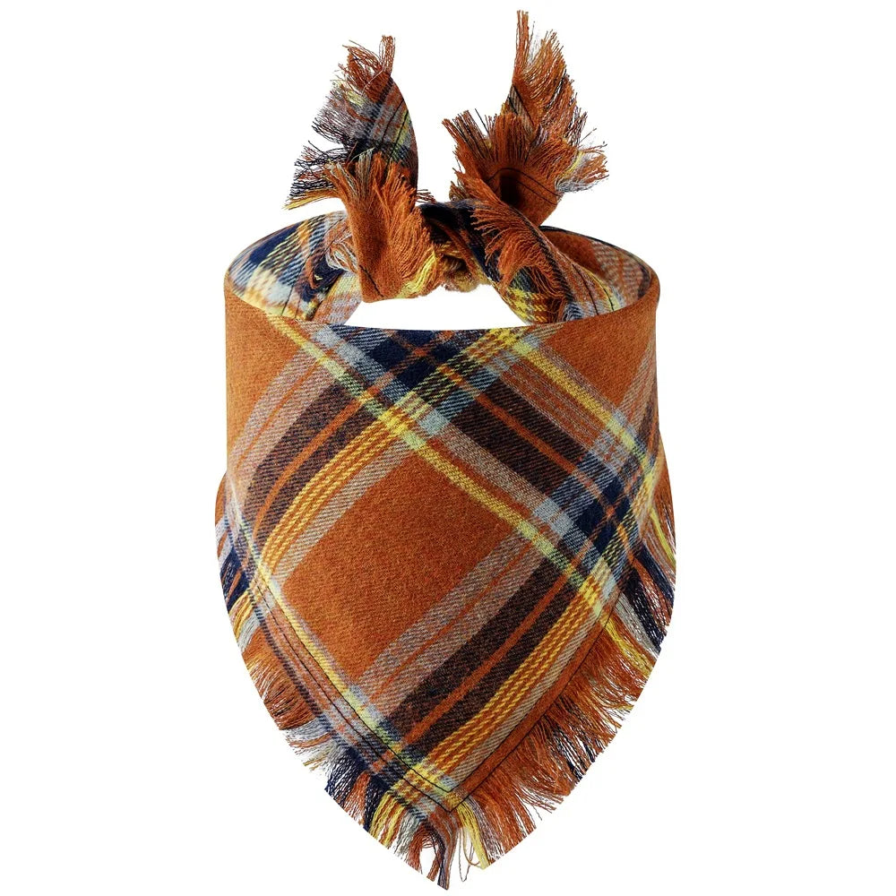 A plaid dog bandana in shades of brown, orange, and blue with fringed edges.