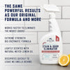 A white spray bottle of Pet Enzyme Stain & Odor Eliminator sits on a gray surface with a lemon slice nearby.
