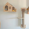 Wooden modular cat wall shelves featuring a house shape with an arched entrance and a cylindrical shelf.