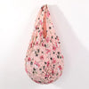 A reusable foldable bubble shopping bag in pink floral print.