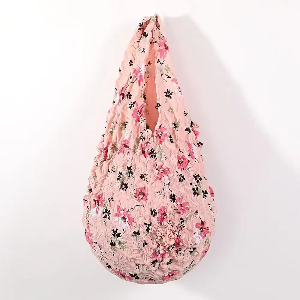 A reusable foldable bubble shopping bag in pink floral print.
